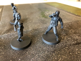 Liam from The Walking Dead: All Out War miniatures game comes under attack from zombies