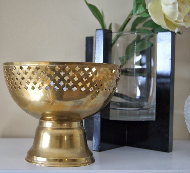 A gold bowl on the desk.