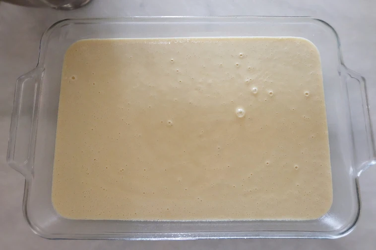 hot milk batter in baking pan