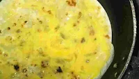 Coating eggs with paratha for chicken roll