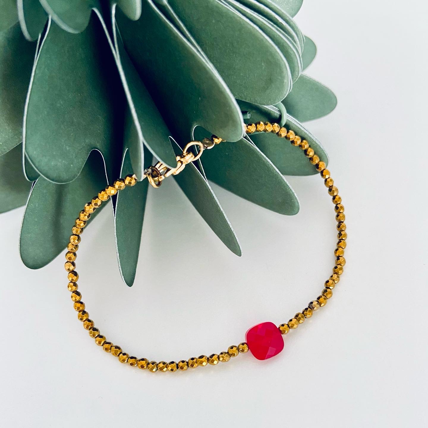 . Zatte B . 371 . Hematite and red glass bead Bracelet.