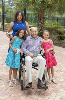 An African American family attending church with the father being in a wheelchair.