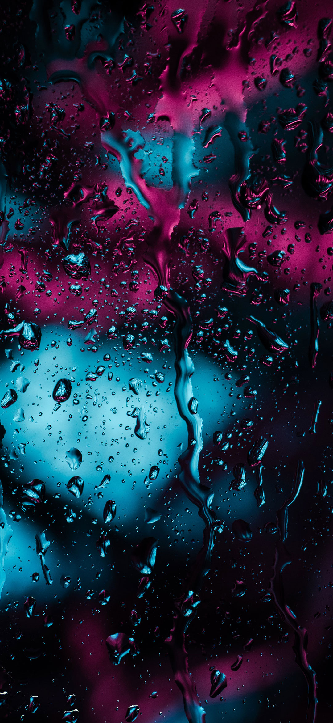 raindrops-on-glass-surface-at-night-wallpaper