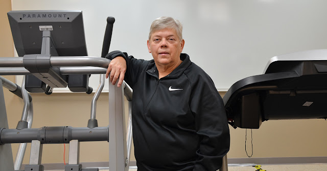 Woman stands in front of excercise equipment