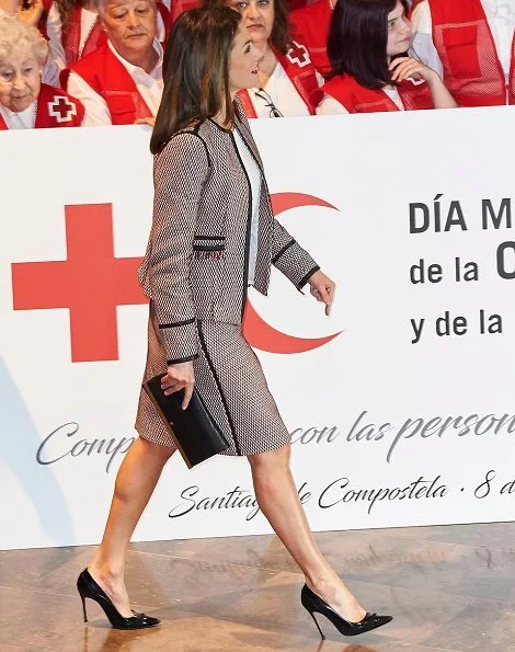 Queen Letizia wore Hugo Boss Keili Jacket and Meili Skirt, and wore Carolina Herrera black patent and suede pumps, and carried Carolina Herrera clutch