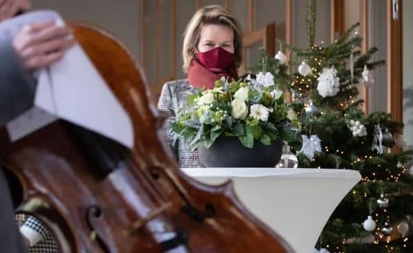 The Queen Elisabeth Music Chapel. Queen Mathilde wore a checked print long coat from Natan, and burgundy mask from Natan, Armani silk blouse