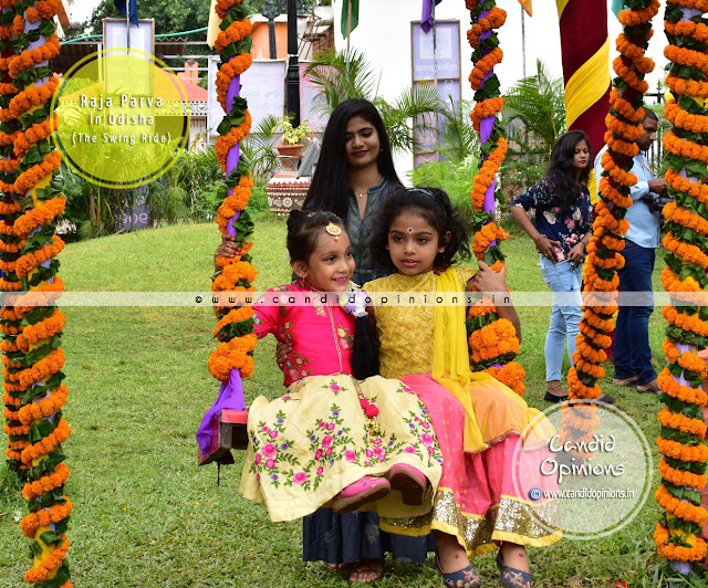 Girls enjoying a swing ride during Raja festival Girls enjoying a swing ride during Raja festival