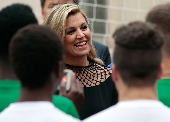 Queen Maxima and King Willem-Alexander attended a Football Clinic. Queen Maxima wore black long dress in Milan