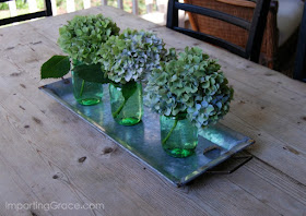 Centerpiece for dining table composed of galvanized tray holding Mason jars and flowers Simple and lovely!