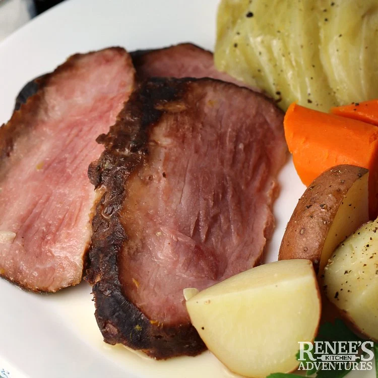 Close up of sliced cottage ham on white plate ready to eat