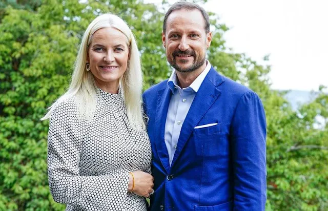 Crown Princess Mette-Marit wore a high neck belted polka-dot silk midi dress by Diane von Furstenberg. Malone Souliers Brenda stripe pumps