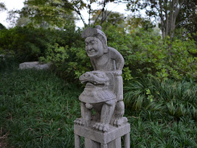 Chinese sculpture of a person riding a lion 