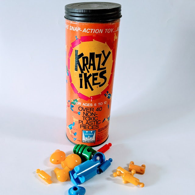 image of a vintage game in a cardboard tube and plastic pieces