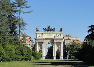 The Arco della Pace seen from within the green space of the Parco Sempione in Milan