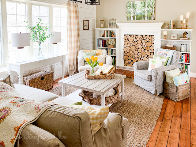 Cozy and Colorful Country Cottage Home Tour - Cute, cozy farmhouse living room with cottage style! Log filled fireplace, checks and florals mix for a comfy and inviting gathering space! Cozy and Colorful Country Cottage Home Tour