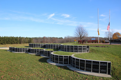 Shows 2 different slight elevation changes like what a rice paddy would look like. Honor stones are mounted along the elevation changes with names of the fallen.