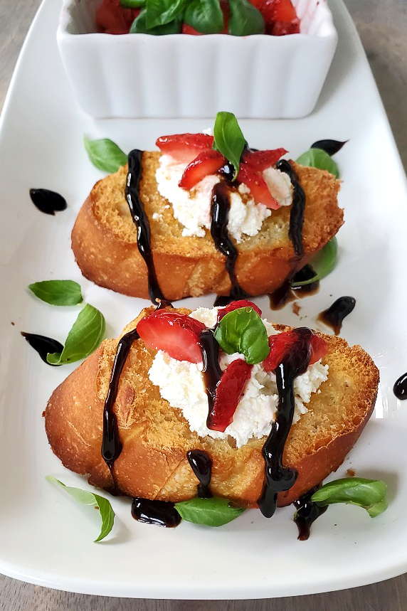 this is baguette bread with ricotta and strawberries on top