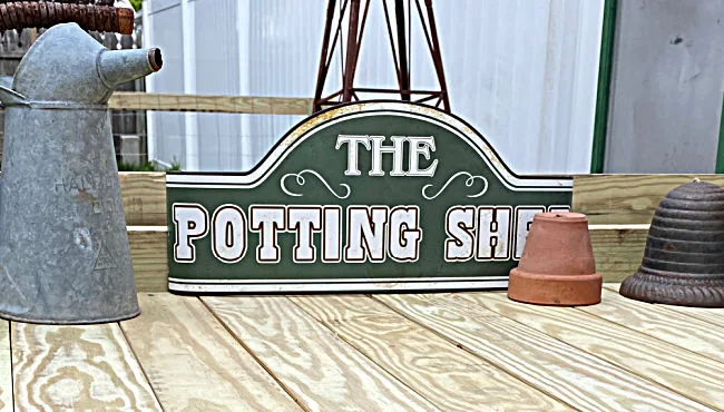 wooden potting bench and potting shed sign