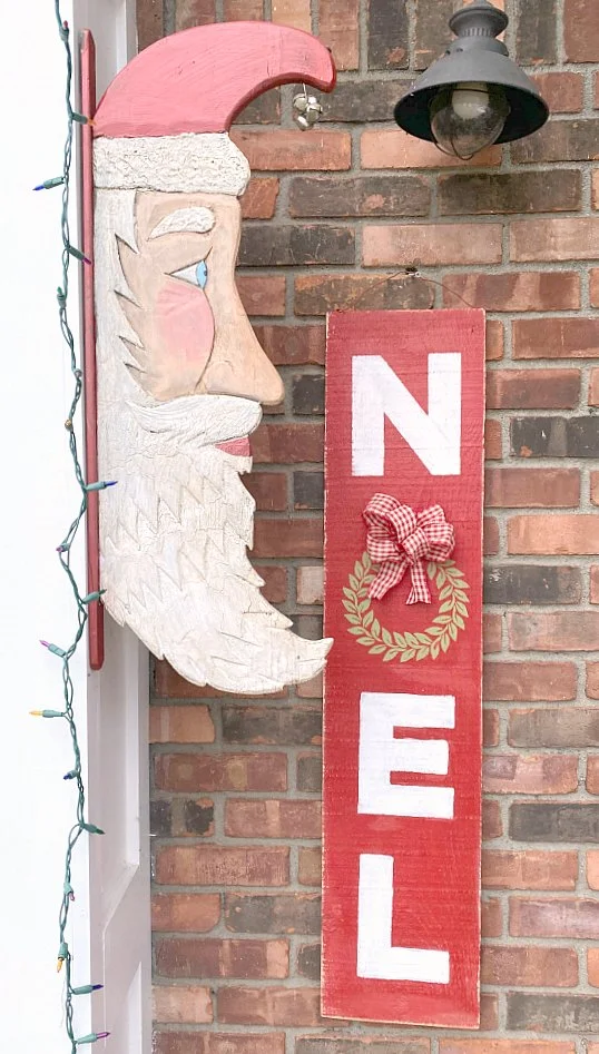 Noel sign hanging outdoors with santa head