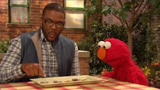 Tyler Perry shows to Elmo his math plate and math skills. Sesame Street Episode 4420, Three Cheers for Us, Season 44