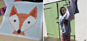 My finished fox cross stitch and my teen hanging the washing out