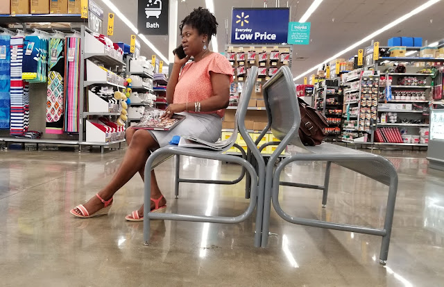 A woman on the phone in Walmart Stopping to take time to help a friend
