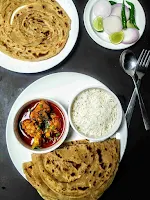 Serving wheat parotta with curry