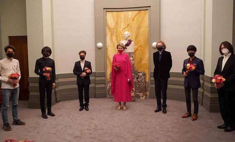 Queen Mathilde wore a red fuchsia silk gown from spring summer 2020 collection of Natan. Queen Elisabeth Piano Competition 2021