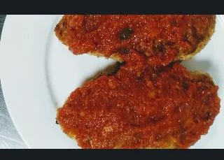 Chicken breasts topped with tomato sauce for healthy chicken parmesan recipe