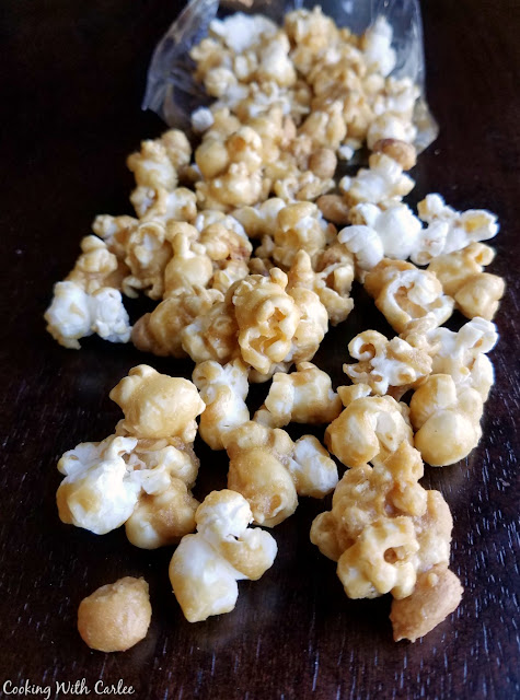 This recipe makes the perfect crunchy, buttery caramel corn. It is perfect for a party and just like what you get at the baseball stadium. The best part is you can make it ahead! golden crunchy caramel coated popcorn and peanuts