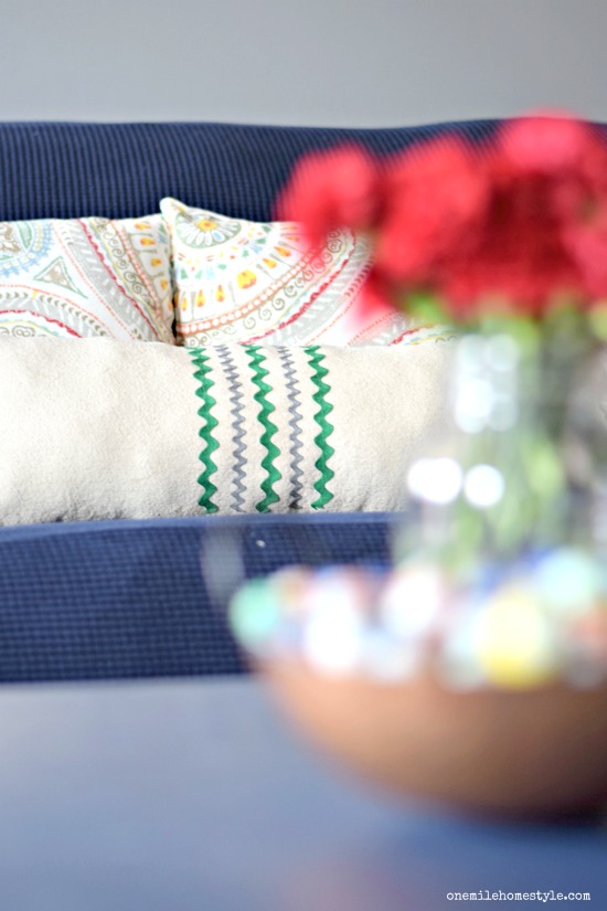 Raid your craft supplies and make your own fun embellished pillow from a drop cloth!