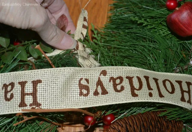 Happy Holidays ribbon tied around two wreaths