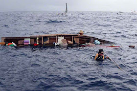 capsized sabani boat, team in deep ocean, rough seas