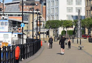 Early morning walkers and joggers on Newcastle Quayside