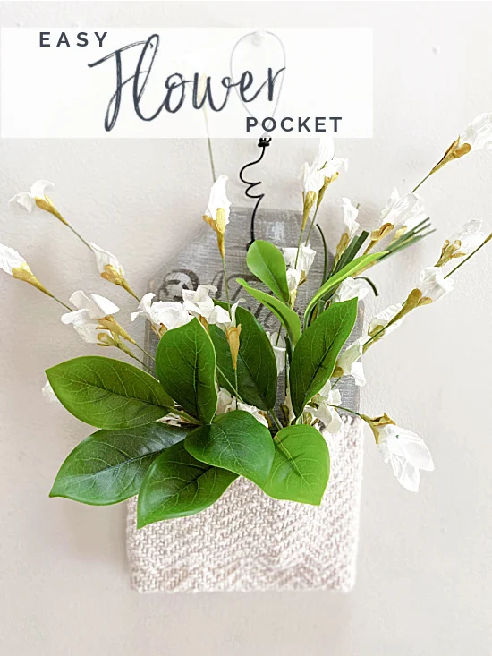 wall pocket with white flowers and overlay