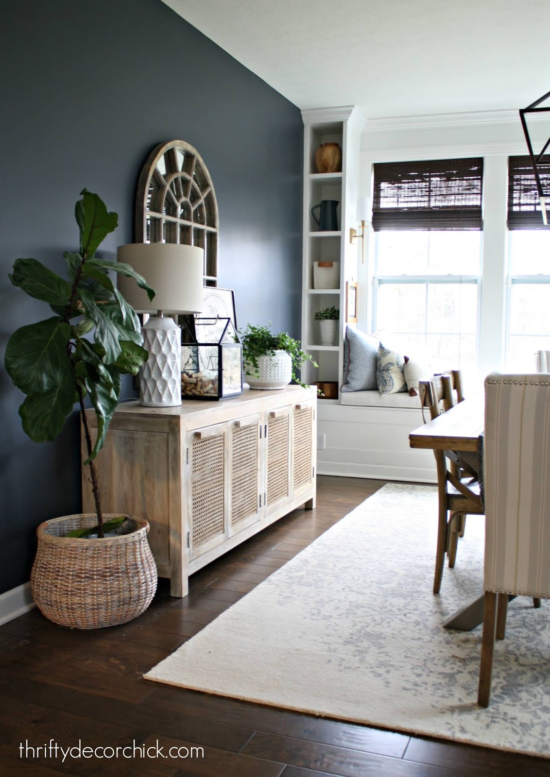 Dark wall dining room with built in window seat