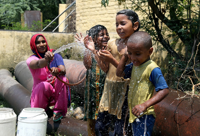 Children take bath in a pond to beat the heat near India Gate during a hot summer day, in New Delh Children take bath in a pond to beat the heat near India Gate during a hot summer day, in New Delh