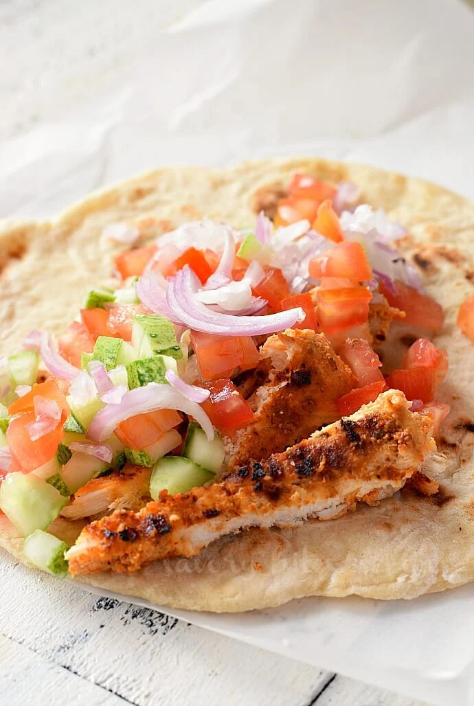 a pita bread with shredded chicken and veggies