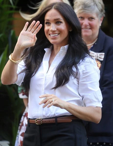 The Duchess wore a Misha Nonoo shirt, Jigsaw Paris slim tapered trousers, a Polo Ralph Lauren saddle tan nappa leather skinny belt