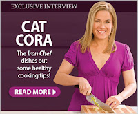 Cat Cora, the Iron Chef smiling and chopping something