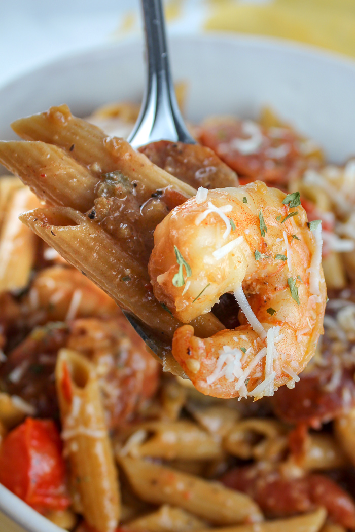 This Cajun Shrimp and Sausage Pasta is quick to make and you can have it as spicy as you like! Fat Tuesday and Mardi Gras won't know what hit 'em! Pasta mixed with shrimp, andouille, onions, peppers & mushrooms all smothered in a spicy creamy tomato sauce! It's heavenly!