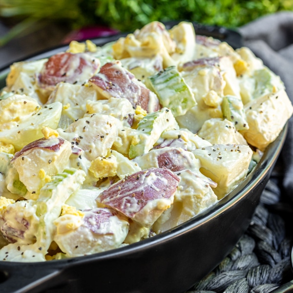 Side view of Mustard Potato Salad in an black bowl.