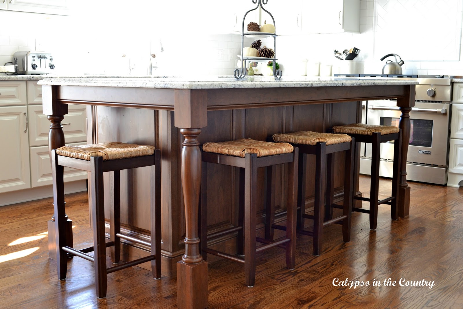Cherry island with counter stools on side and end Cherry island with counter stools on side and end