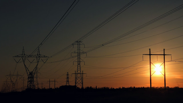 Two large power lines during the sunset