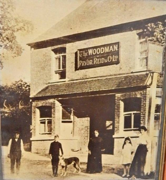 The Woodman as a Pryor Reid pub Photograph of a framed print hanging in the pub