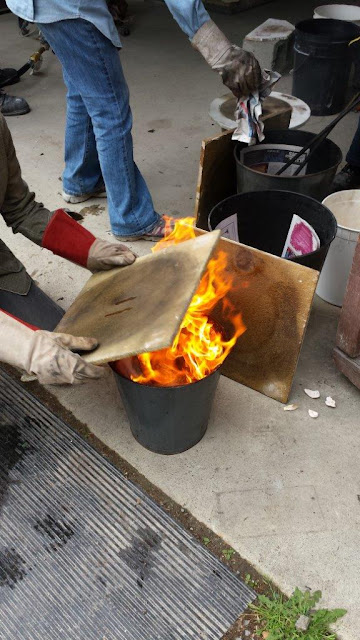Naked raku process - placing the pottery in a can with combustibles.