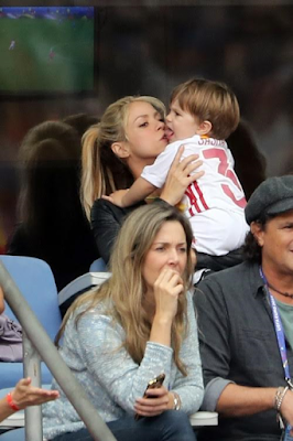 1a3 Shakira and sons cheers on her husband football star Gerard Pique during his game.
