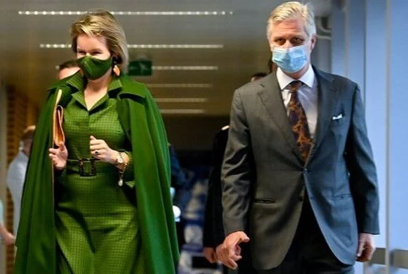 Queen Mathilde wore a green wool cashmere cape coat from Natan, and green checked viscose canvas midi dress from Belgian fashion house Natan
