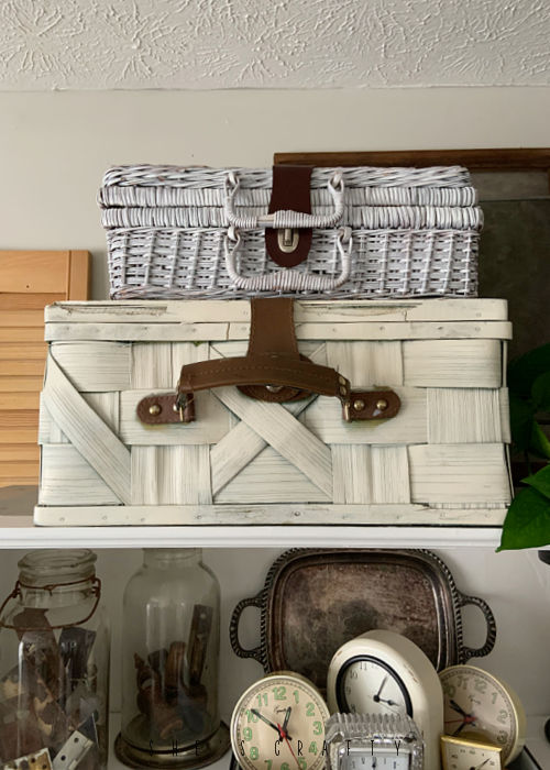 How to use a collection of white picnic baskets to decorate a cupboard.