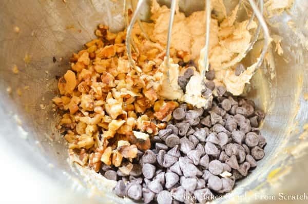 Chocolate Chips and nuts being stirred into Chocolate Chip Cookie Pie Batter from Serena Bakes Simply From Scratch.